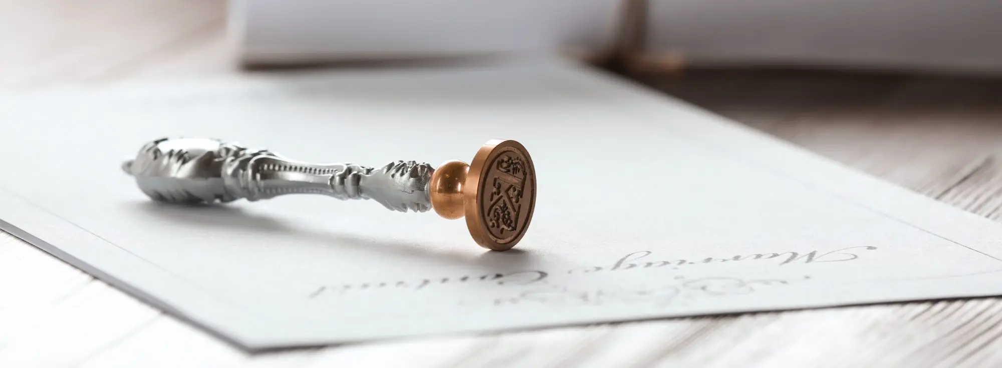 Ornate wax seal stamp with copper head on official document